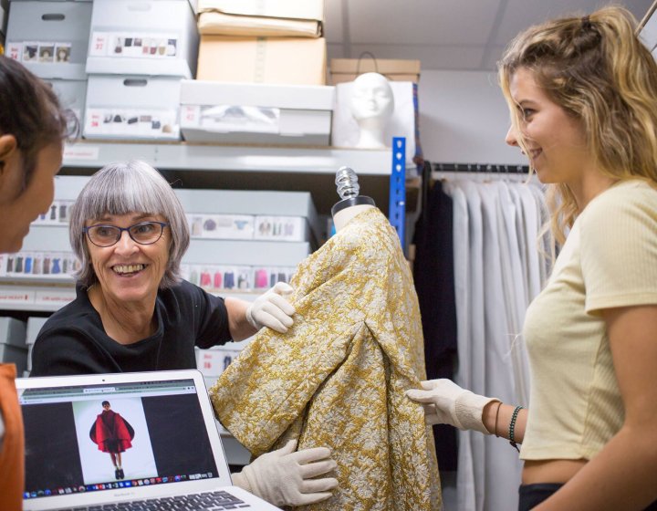 Di Downs working with two students in the costume stores at Falmouth University
